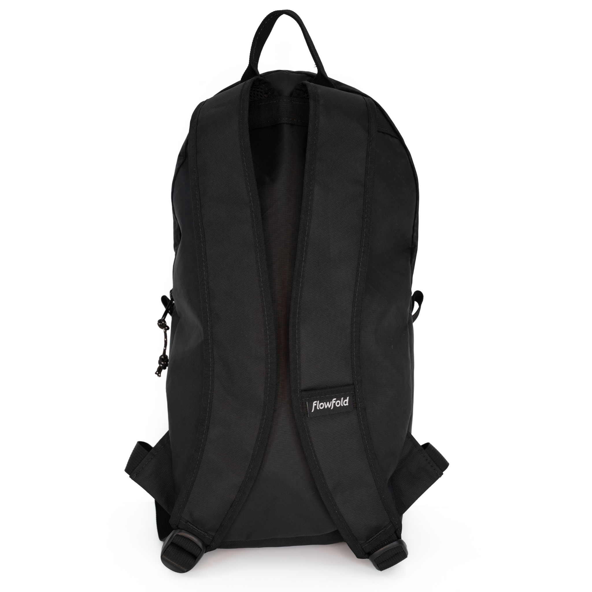 Black Flowfold backpack shown from the back, featuring padded shoulder straps, a top carry handle, and a small white Flowfold logo patch on the lower side, set against a plain white background.