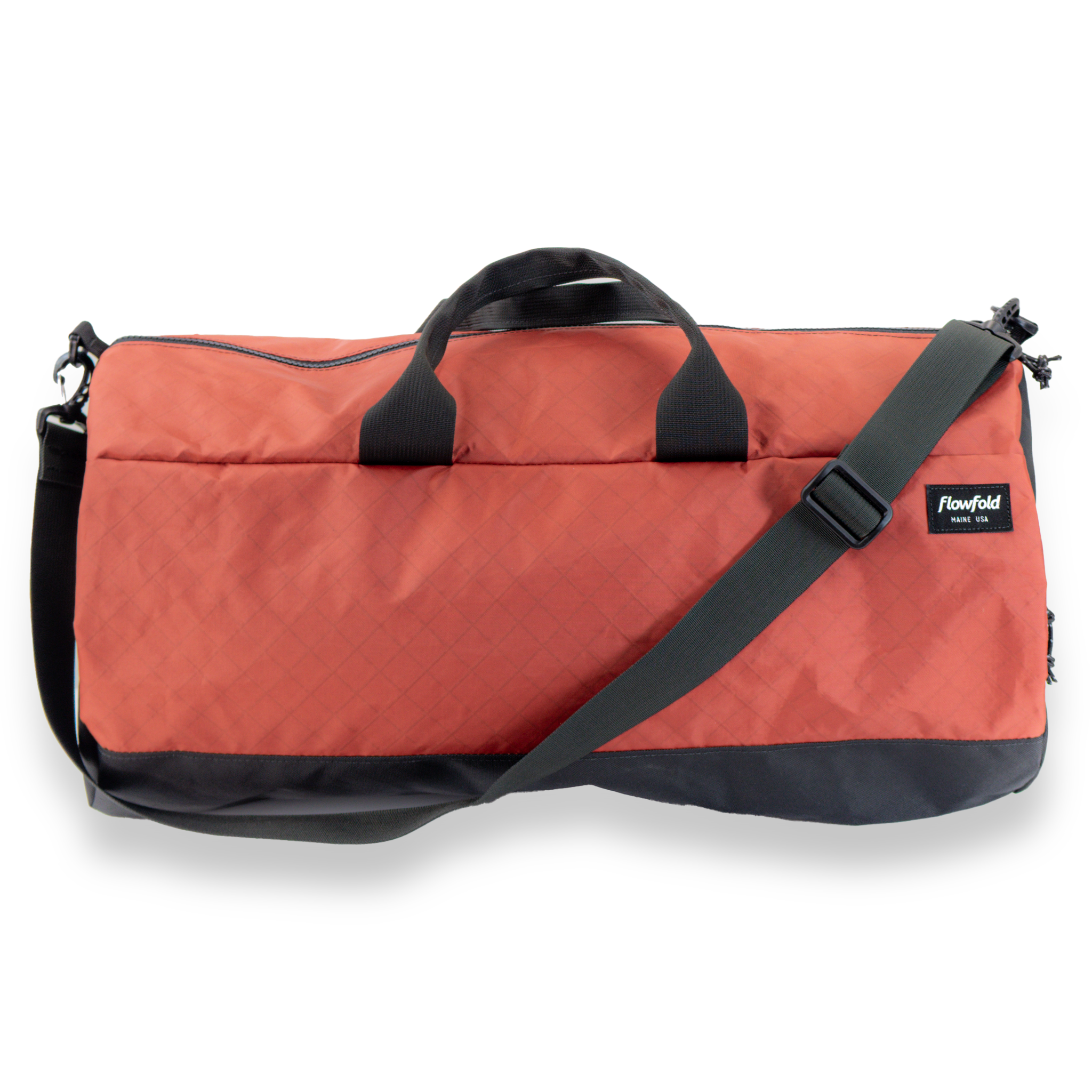 Red duffel bag with black handles and strap on a white background