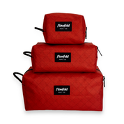 Brick red aviator dopp kit stacked on top of each other