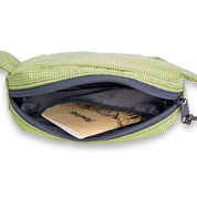 Olive green belt bag with a notebook inside showing an interior zipper pocket on a white background