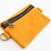 Yellow leather wallet with zipper on a white background