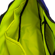 Neon yellow interior lining of the crescent shaped crossbody bad with two slip pockets, a zip pocket, and a key leash.