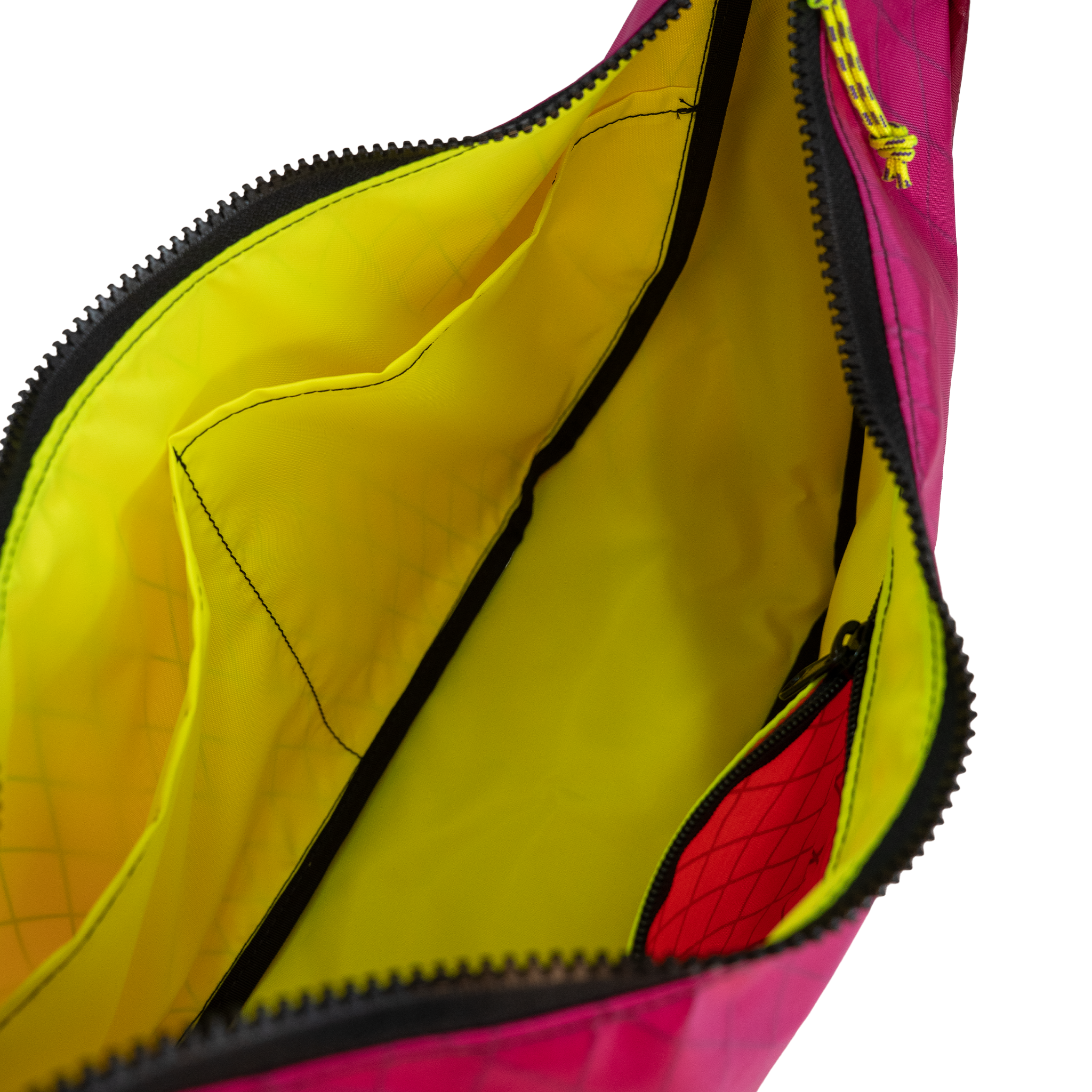Yellow interior lining of the crescent shaped crossbody bad with two slip pockets, a zip pocket, and a key leash.