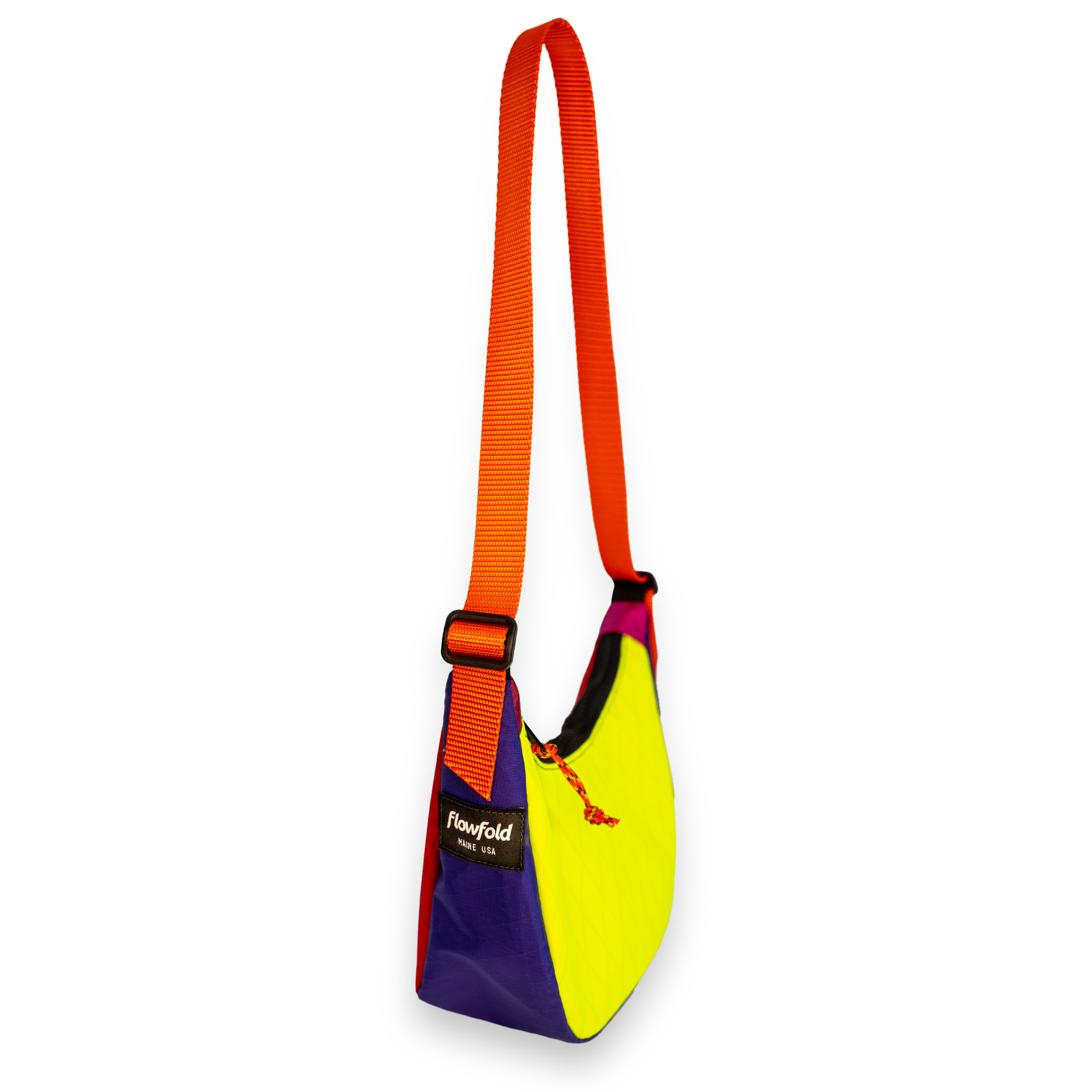 Purple and yellow  color blocked mini crescent shaped crossbody bag with an orange strap