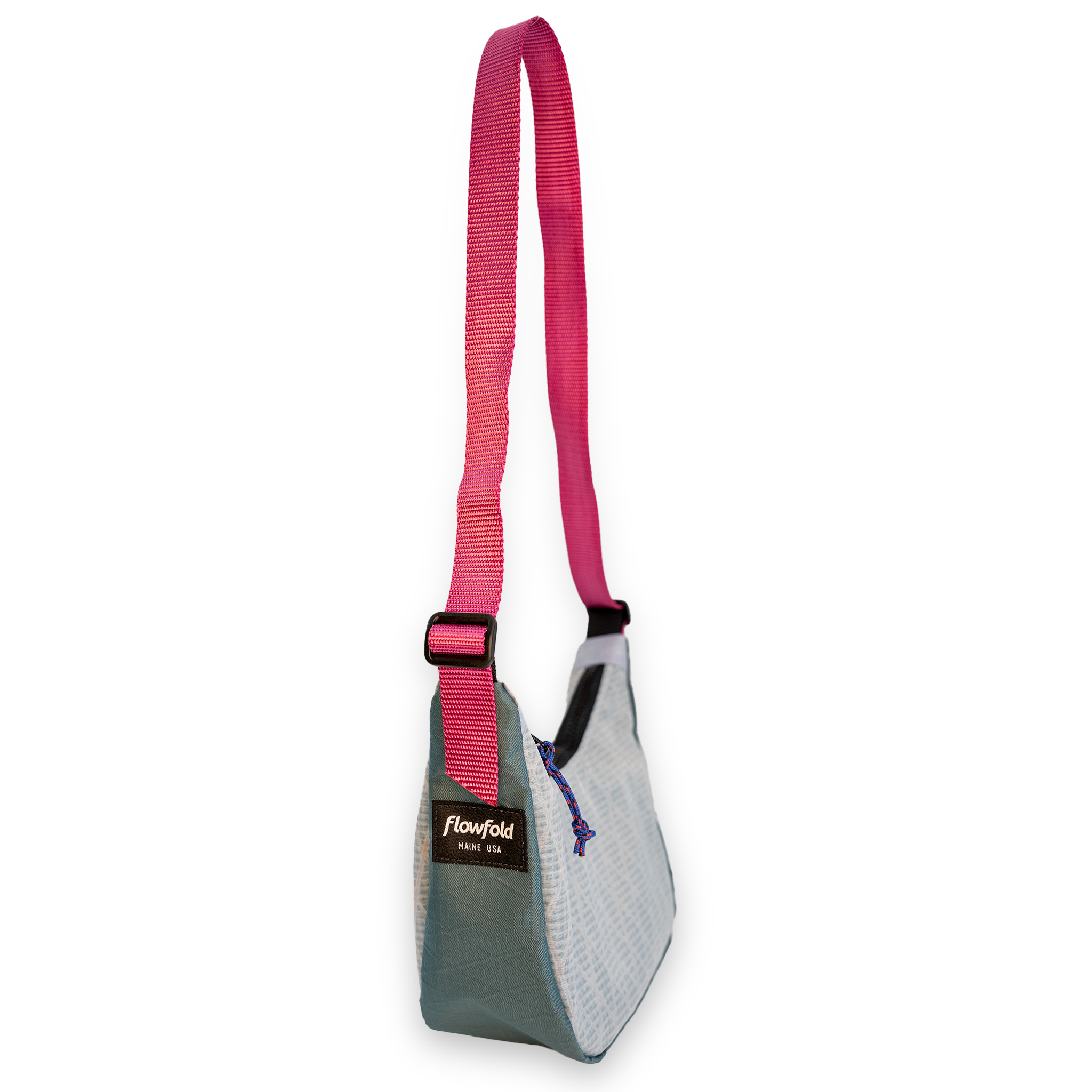 A Flowfold shoulder bag with a bright pink adjustable webbing strap, a light gray woven body, and a dark gray-green bottom panel, shown on a plain white background.