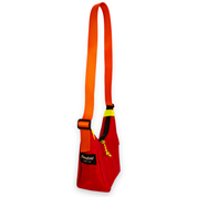 Red color blocked mini crescent shaped crossbody bag with an orange strap