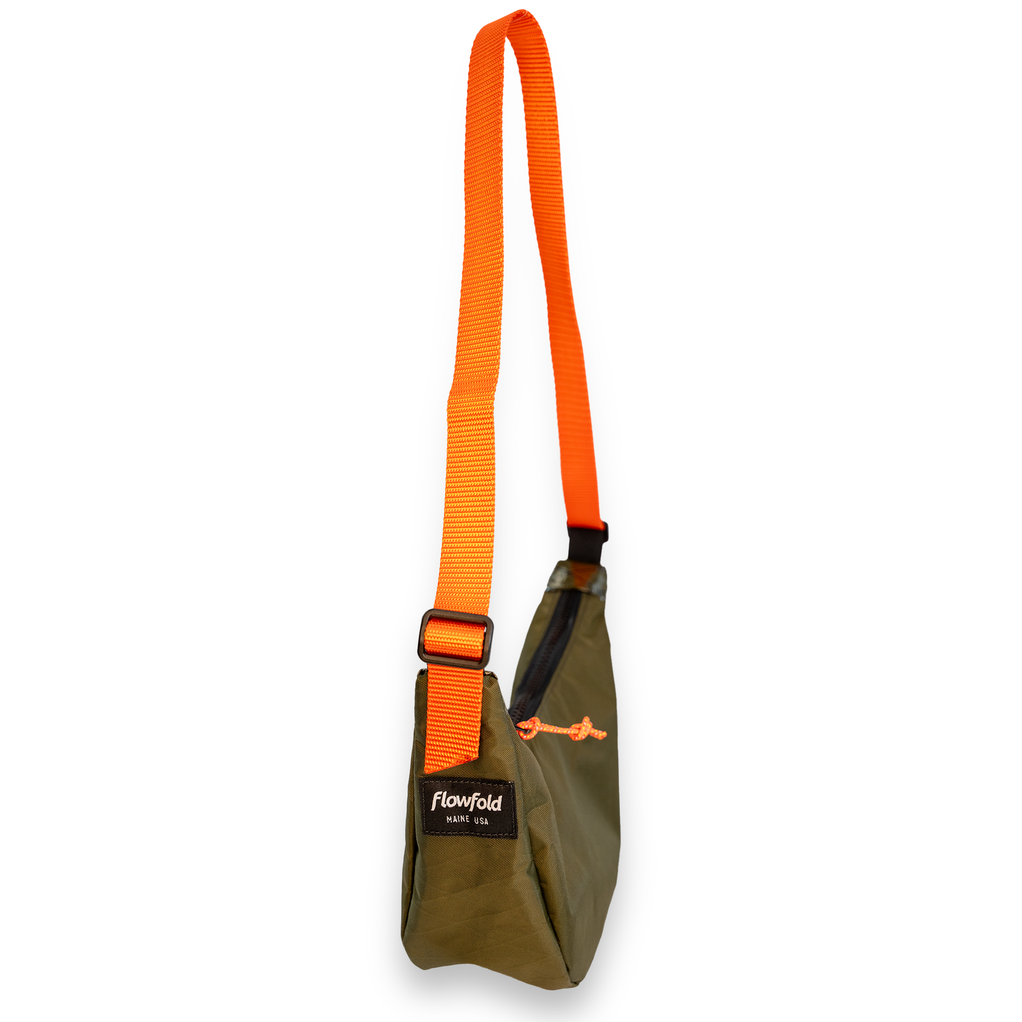 An olive green and bright orange Flowfold sling bag with a wide adjustable orange webbing strap, shown against a plain white background.