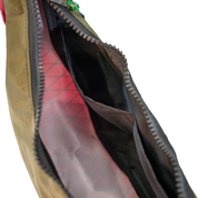 Close-up of an open bag showing a black interior, and zipper.
