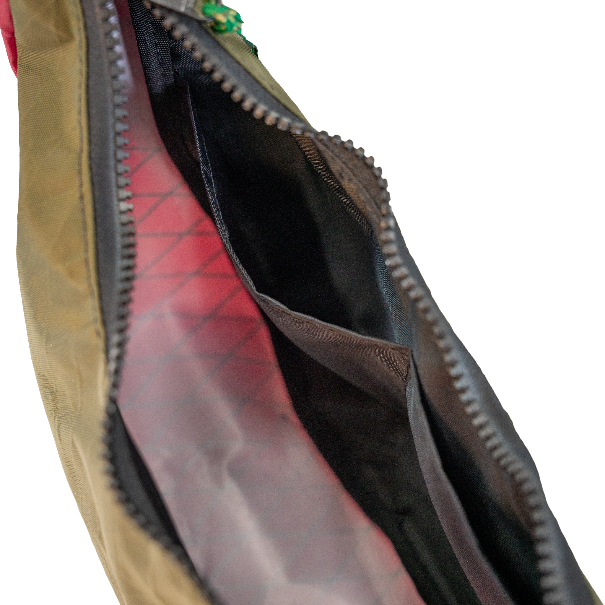 Close-up of an open bag showing a black interior, and zipper.