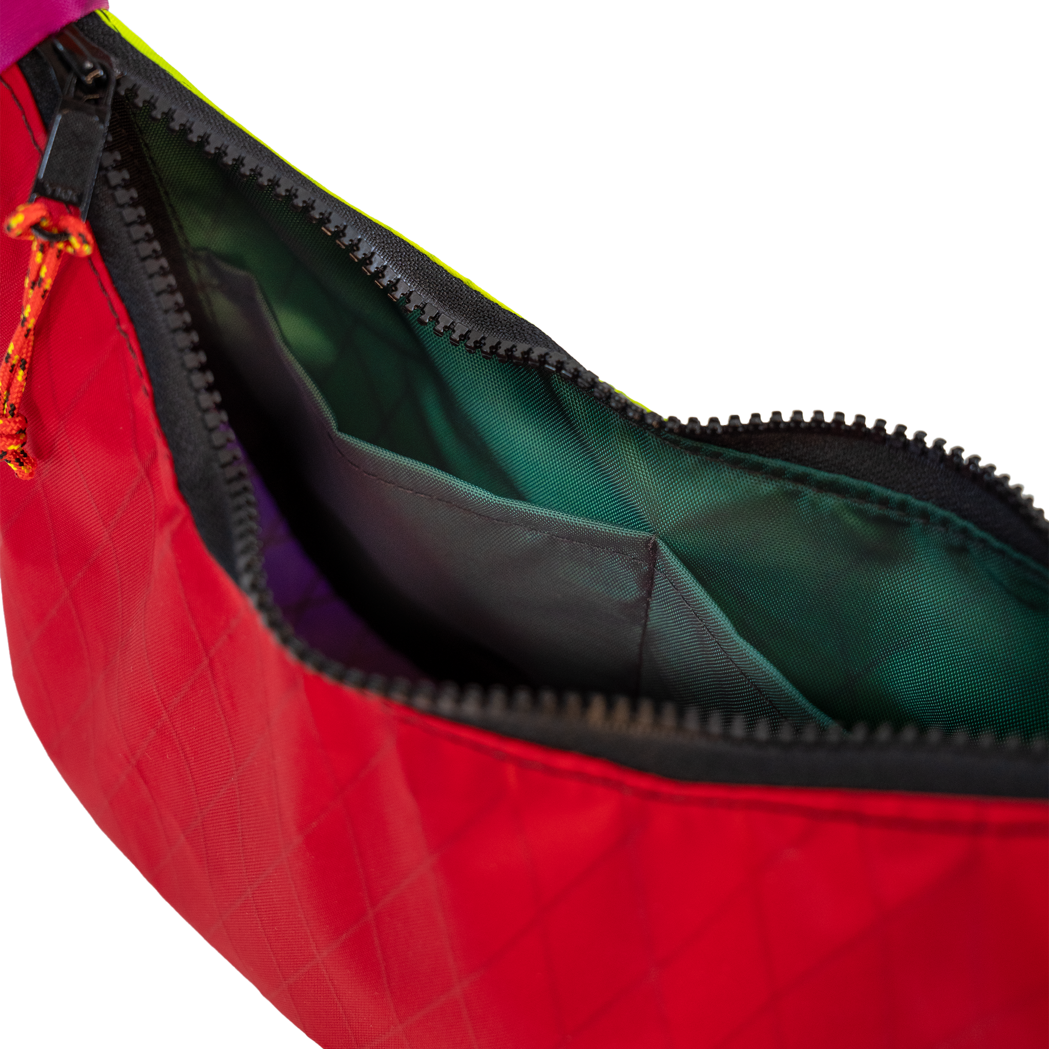 Close-up of a red bag with an open black zipper, showing a dark green interior lining and a small orange-and-black zipper pull on a white background.
