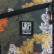 Kelp -patterned bag with JKP Flowfold logo on a dark background