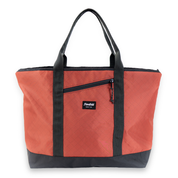 Red tote bag with black handles and trim on a white background