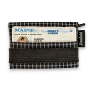 Black and white checkered wallet with a Maine driver's license inside, on a white background.
