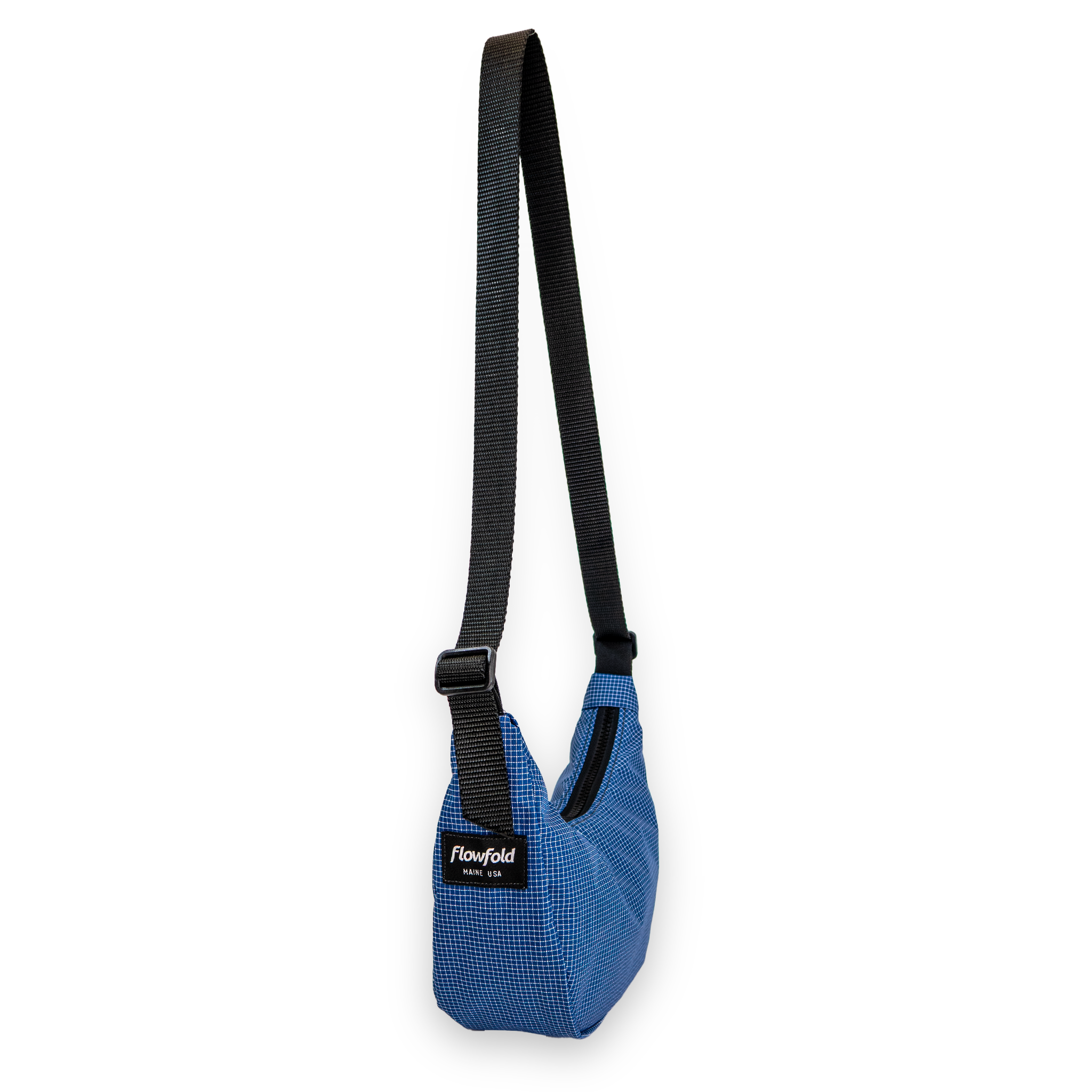 Blue crescent bag with a black strap on a white background at an angle