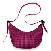 Pink checkered bag with a matching pink strap on a white background