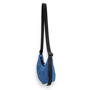 Back of a blue crescent bag with a black strap on a white background