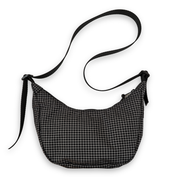 Black and white checkered bag with a strap on a white background