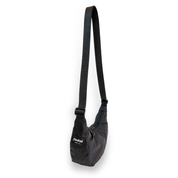 Coal crescent bag with a black strap on a white background at an angle
