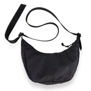 Coal crescent bag with a black strap on a white background