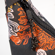 Close-up of a bag with orange and white kelp pattern on a black background