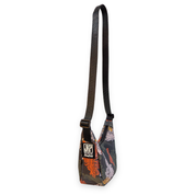 Small crescent shaped bag with a kelp pattern and black strap on a white background