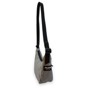 Small gray crossbody bag with a black strap on a white background