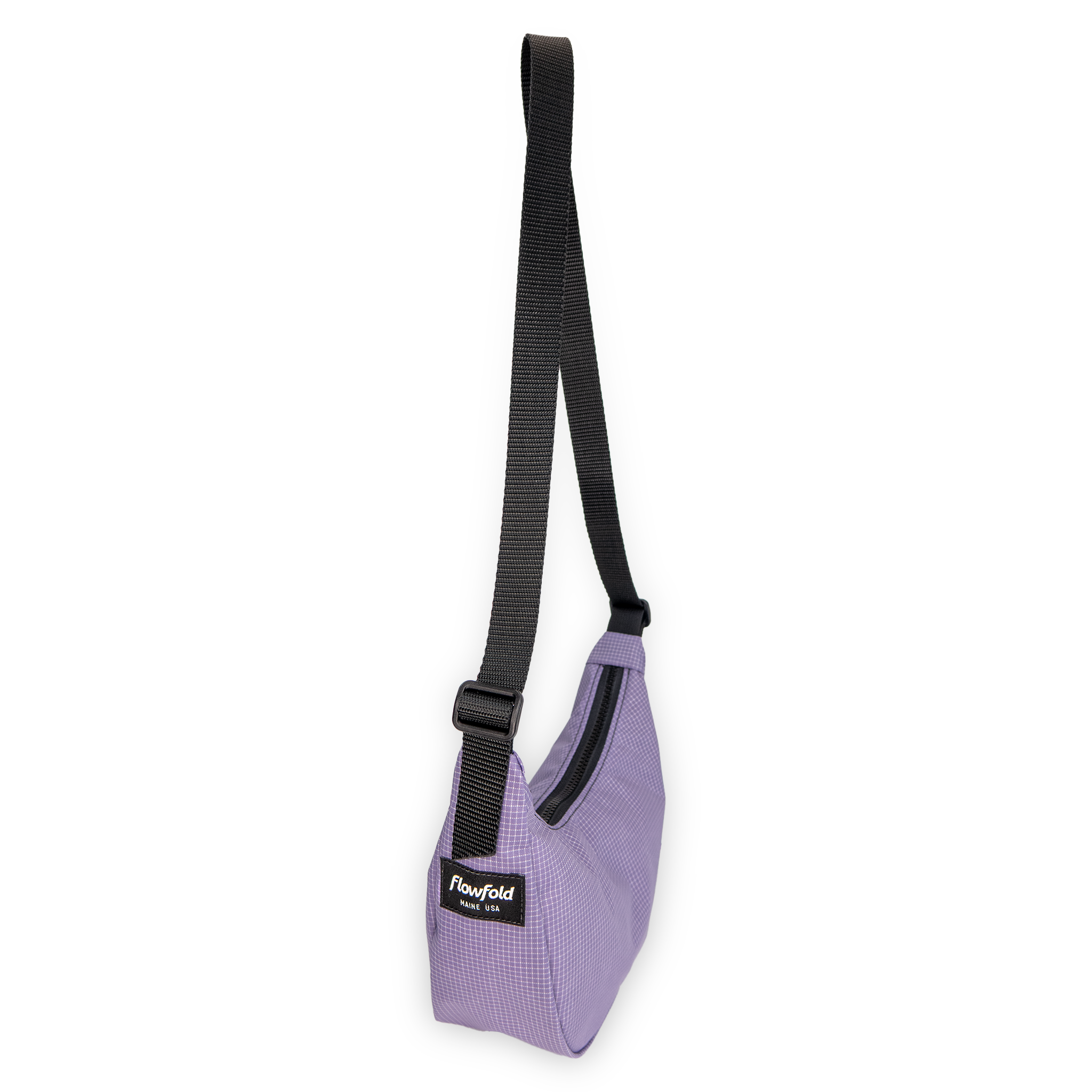 Purple crescent shaped bag with a black strap on a white background