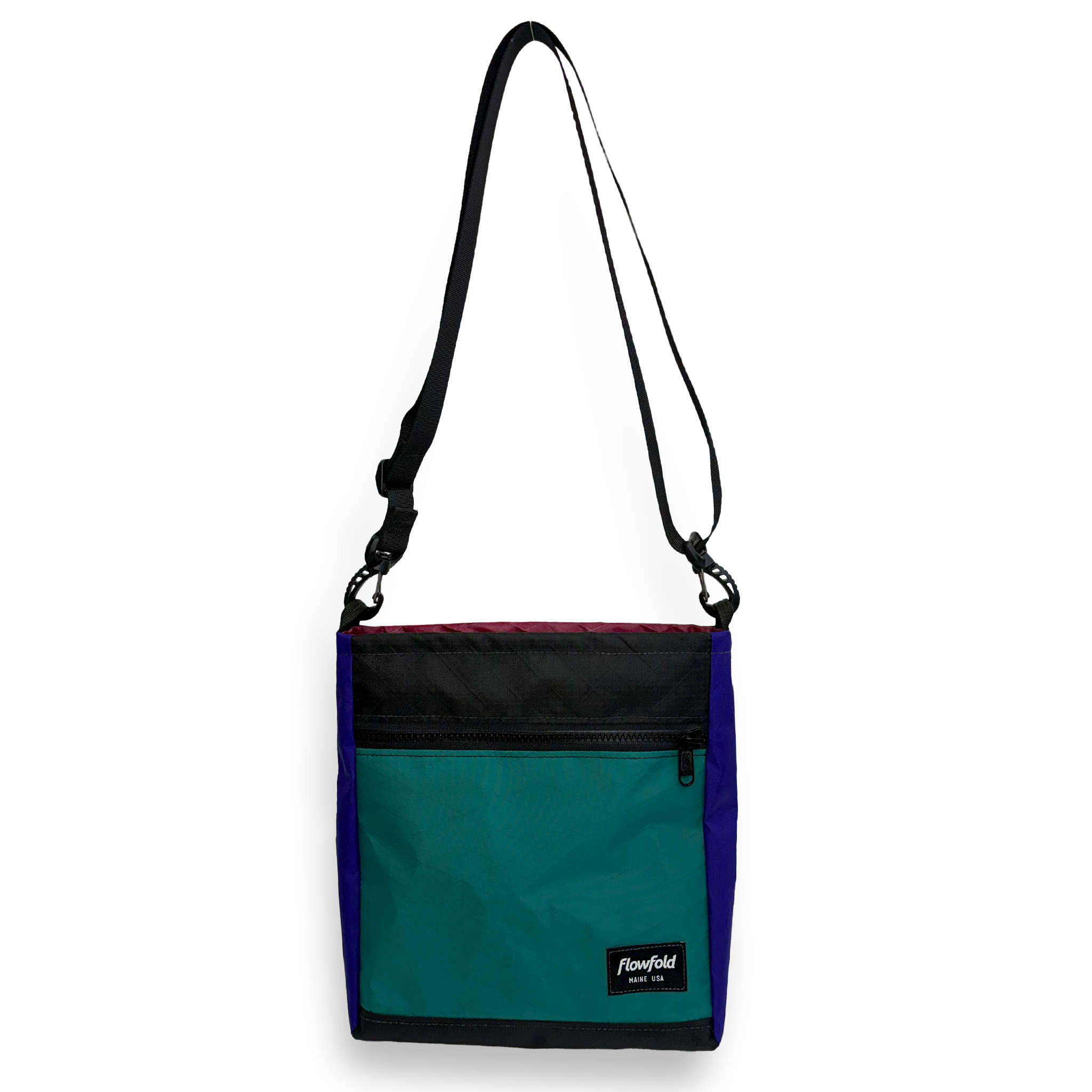 Teal, black, and blue color block crossbody bag with a black strap
