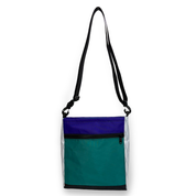 Blue, white, and teal color block crossbody bag with a black strap