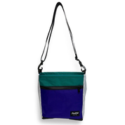 Blue, white, and teal color block crossbody bag with a black strap