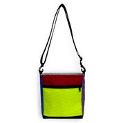 Colorful bag with a black strap on a white background