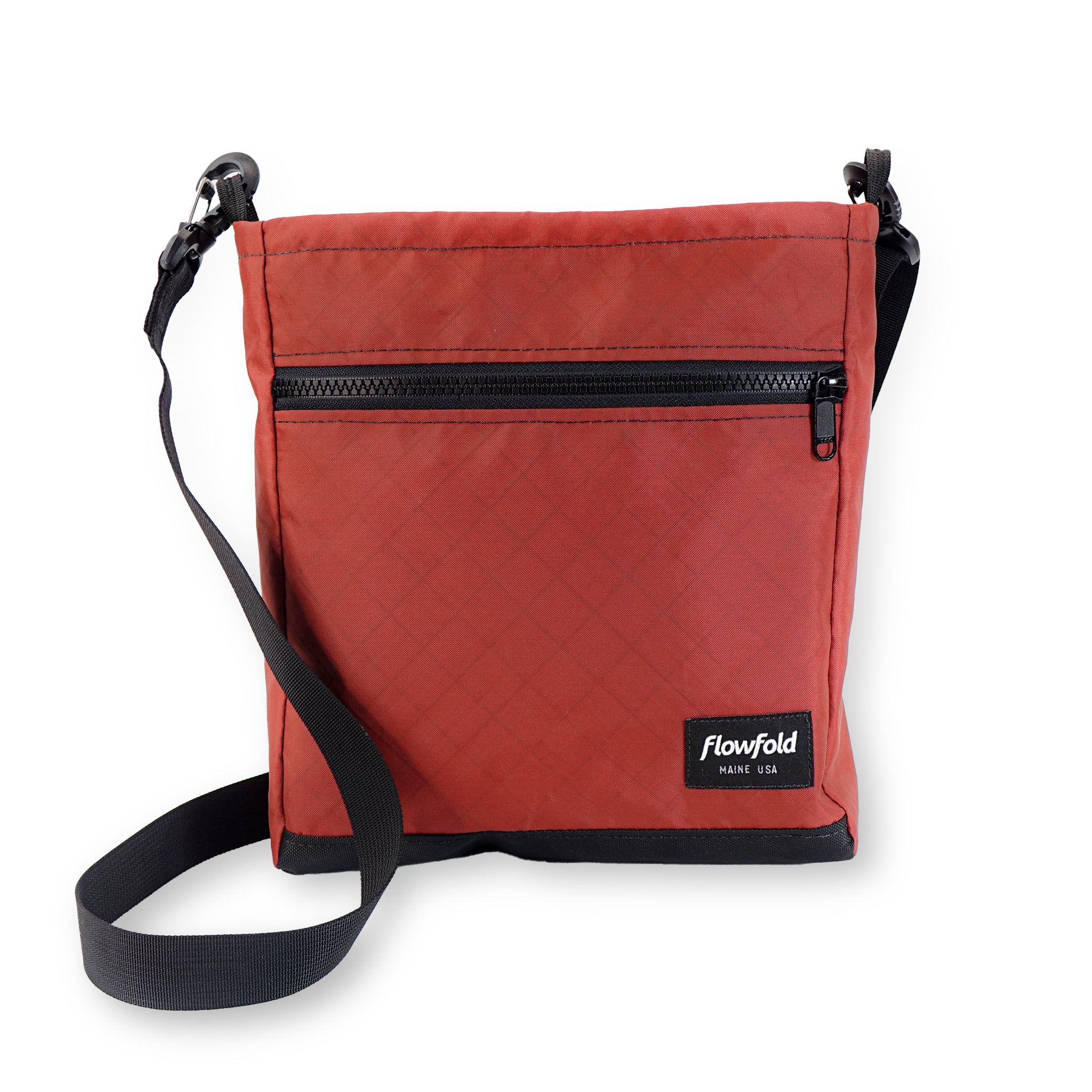 Red crossbody bag with black strap and zipper on a white background