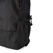 Close-up of a black backpack showing a mesh stretchy outside pocket on a white background.
