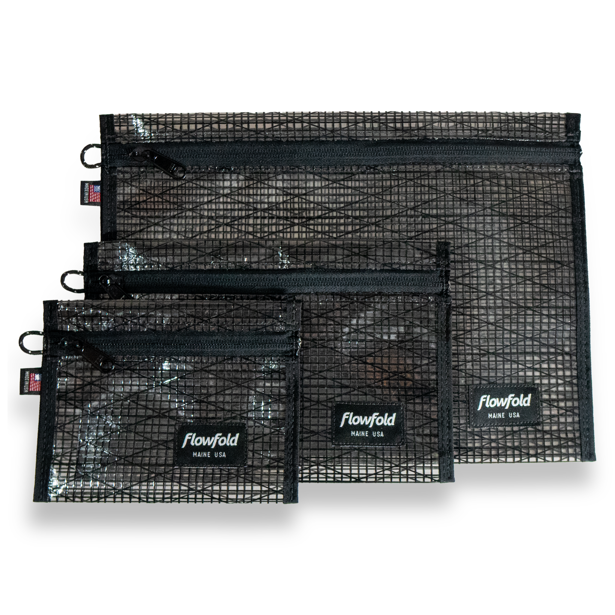 Set of black recycled sailcloth pouches with black zippers and 'Flowfold' branding on a white background