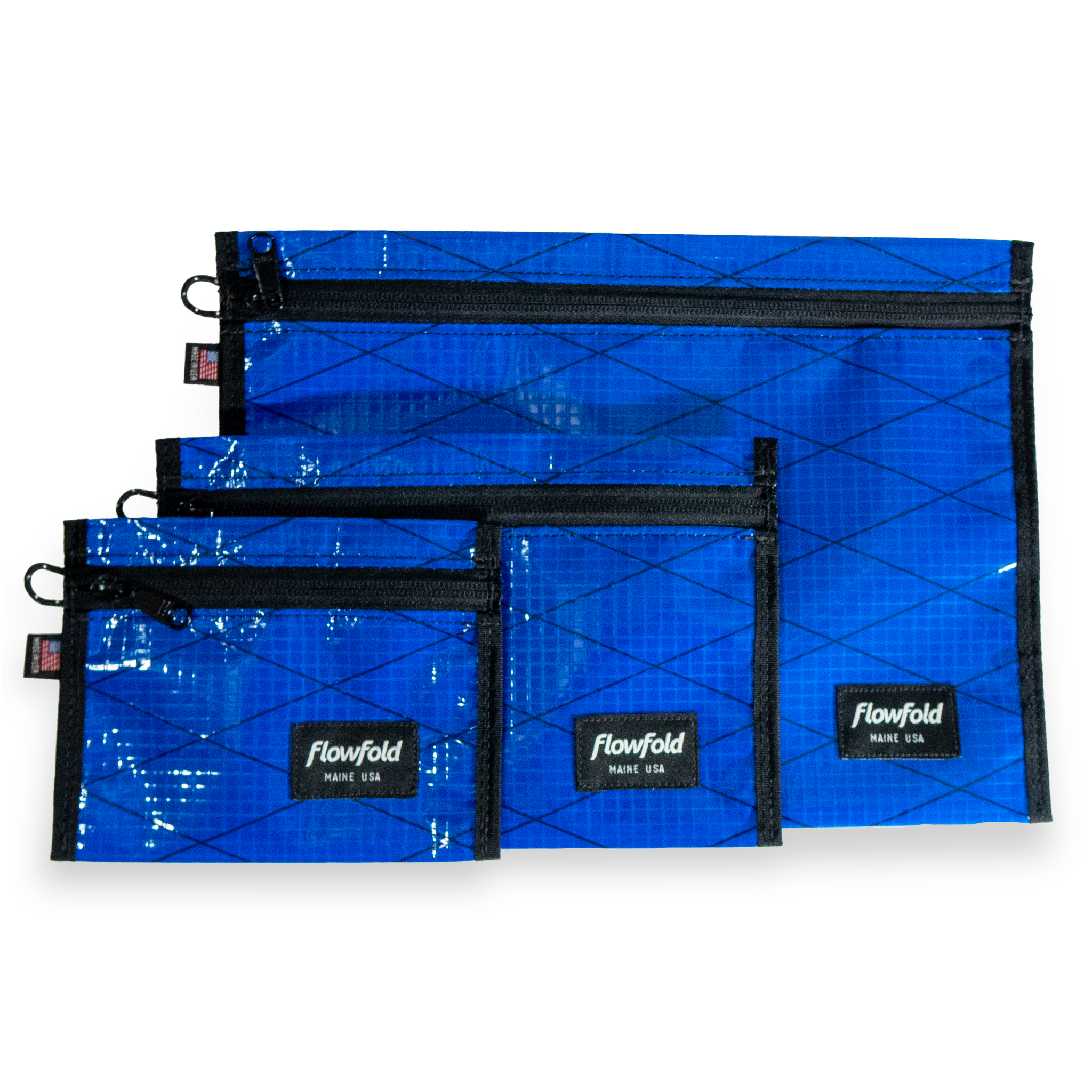 Set of blue recycled sailcloth pouches with black zippers and 'Flowfold' branding on a white background