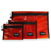 Set of rust colored recycled sailcloth pouches with black zippers and 'Flowfold' branding on a white background