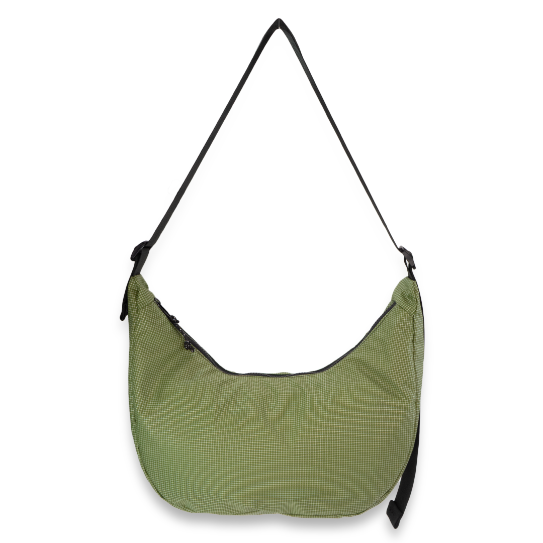Green crescent bag with a black strap on a white background