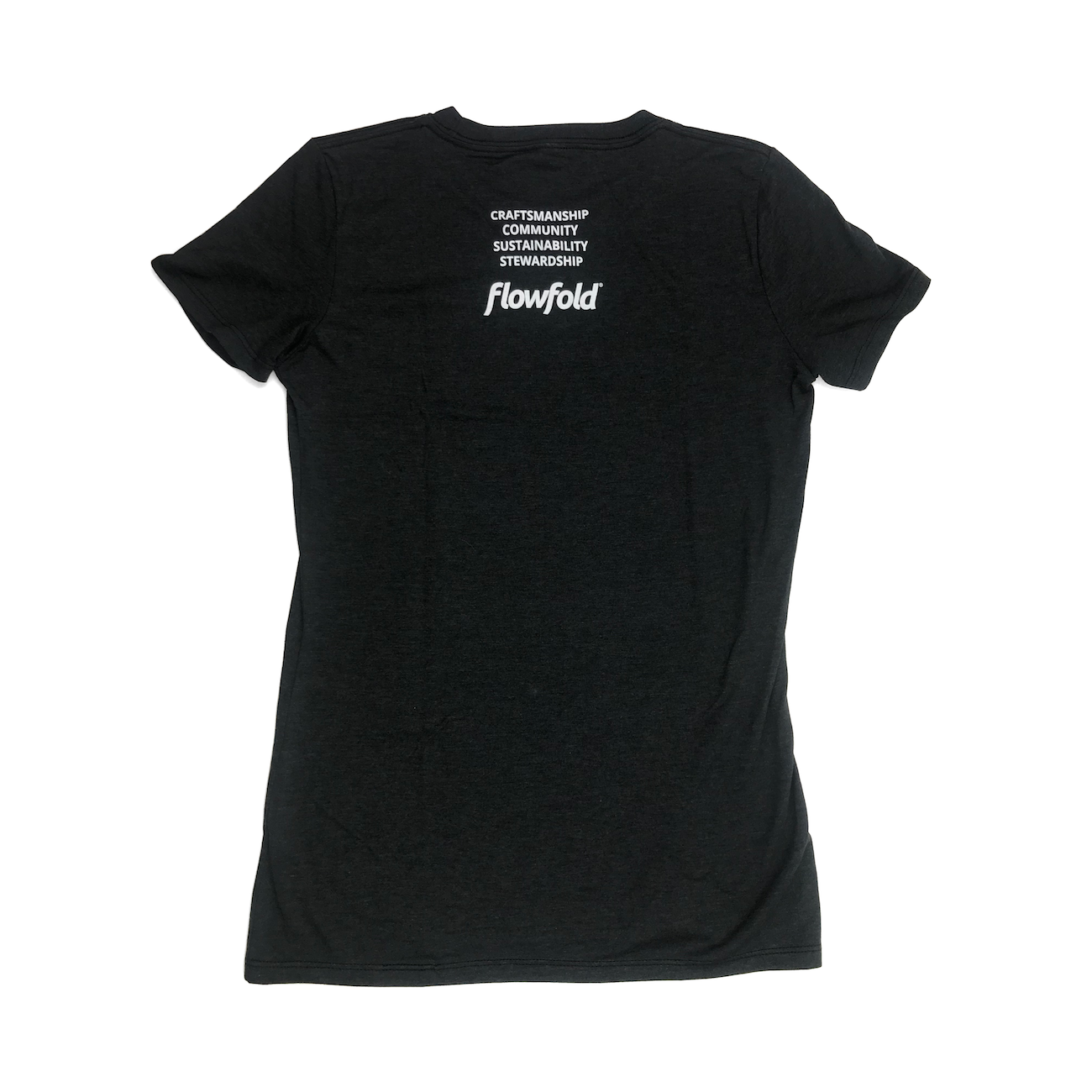 Women’s Black Flowfold T-Shirt back view with stacked saying: Craftsmanship, Community, Sustainability, Stewardship 